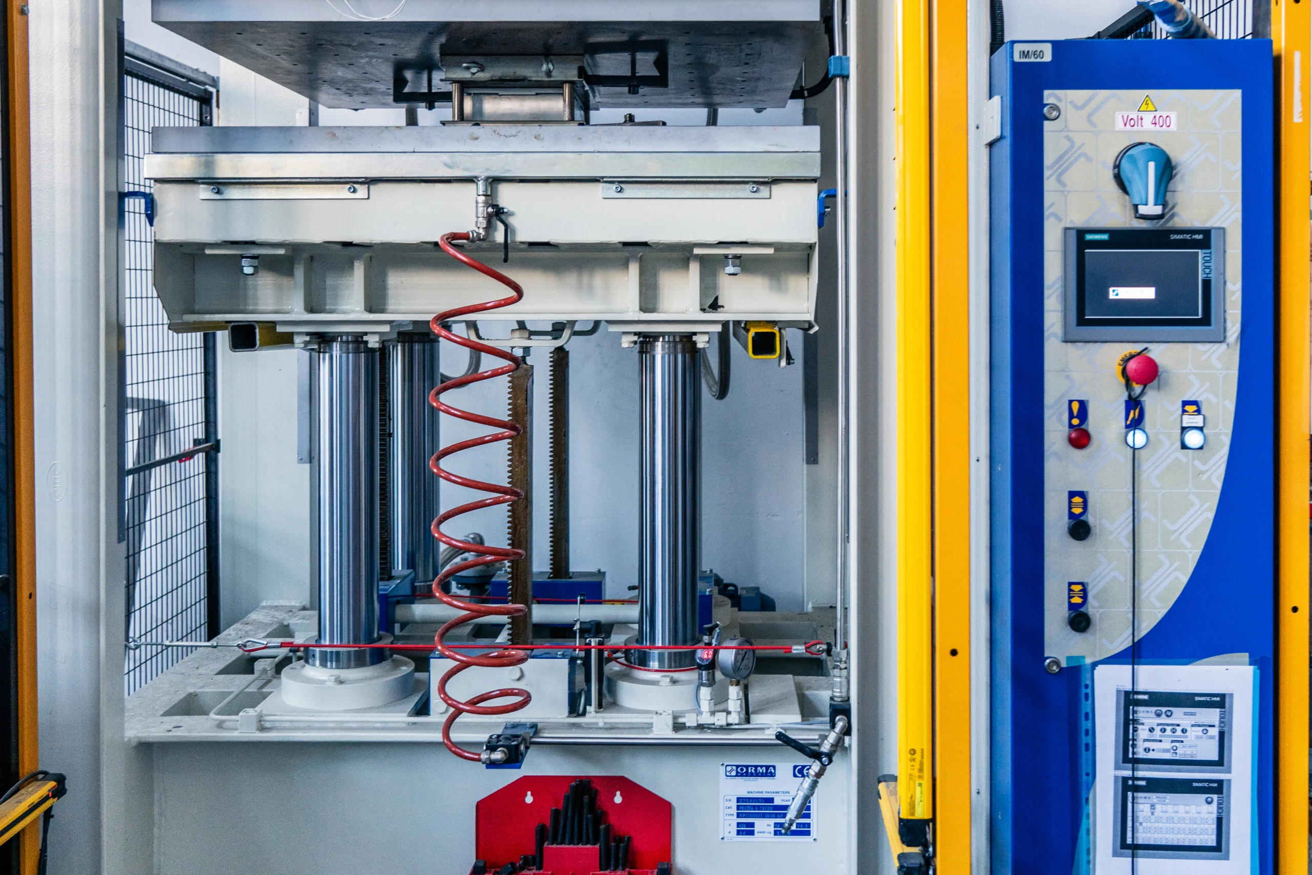 Hot plate press used in manufacturing to shape materials under heat and pressure for Compositex